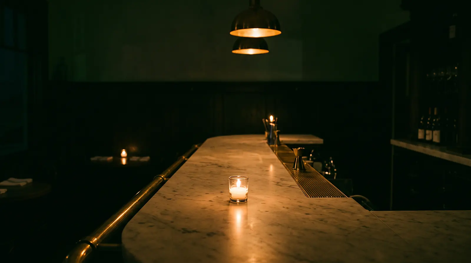 Tidemark's marble bar late at night, a single candle burning on the counter